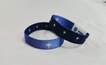 Reversible Christian NFC elastic wristband with a star-filled night sky design on one side and a lighter Bethlehem repeating star pattern on the other.