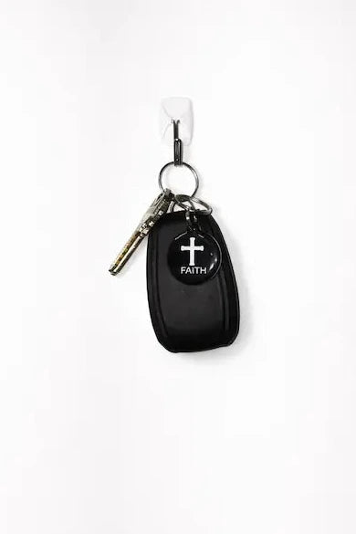 NFC keychain shown on set of keys. Black NFC keychain with white cross and "FAITH" white text.