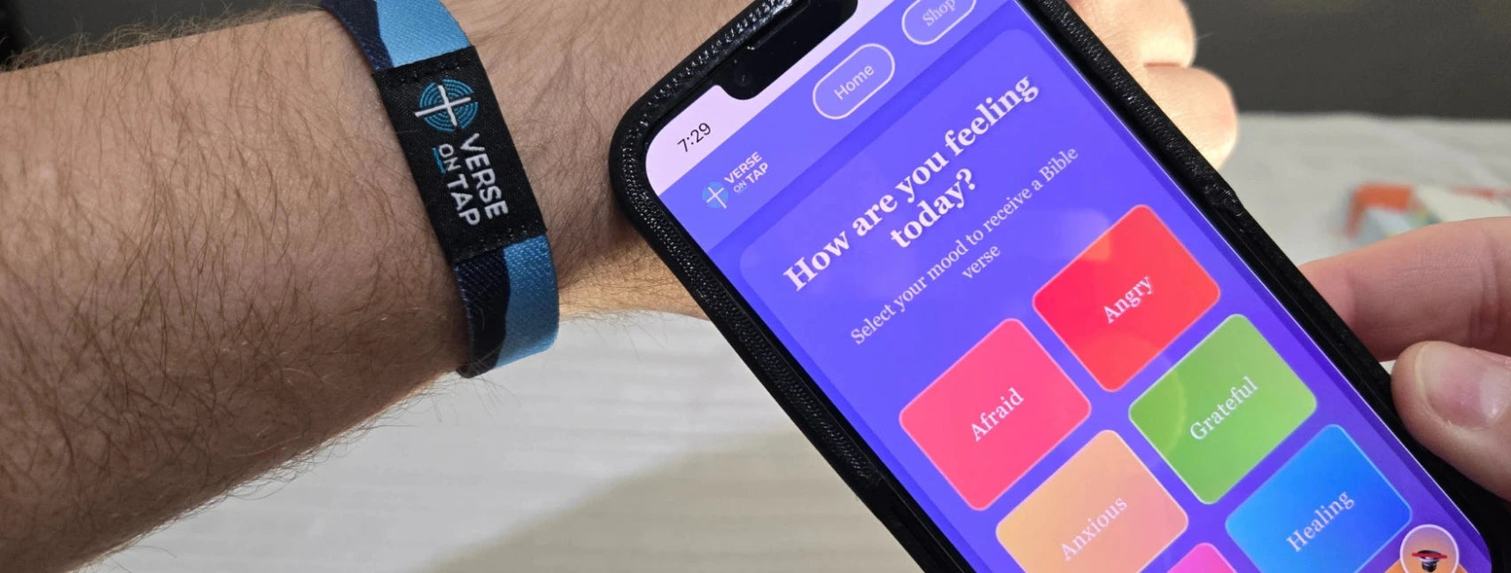 Person holding a smartphone with a Verse on Tap site displaying mood options.